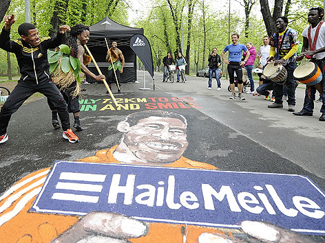 Haile Gebrselassie mit Trommlern und Tänzer während der Eröffnung der nach ihm benannten "Haile Meile" im Wiener Prater